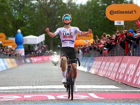 Team UAE's Slovenian rider Tadej Pogacar celebrates as he crosses the finish line to win the 2nd stage of the 107th Giro d'Italia cycling race on Sunday.
