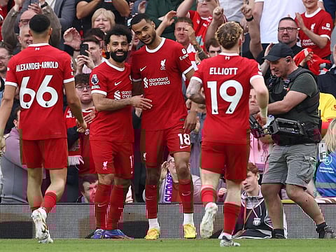 Liverpool's Dutch striker Cody Gakpo (centre) celebrates scoring the team's third goal with striker Mohamed Salah during the English Premier League football match against Tottenham Hotspur at Anfield on Sunday.
