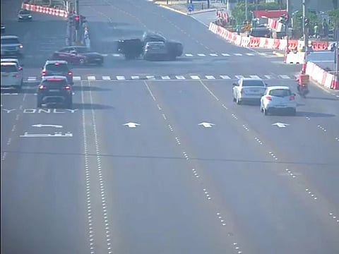 Still from police video showing a collision after a driver jumps the red light at an intersection in Abu Dhabi