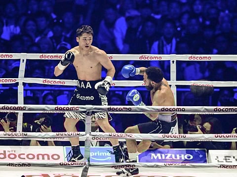 Japans Naoya Inoue (left) knocks down Mexicos Luis Nery during their IBF-WBA-WBC-WBO super-bantamweight title boxing match at the Tokyo Dome on Monday.