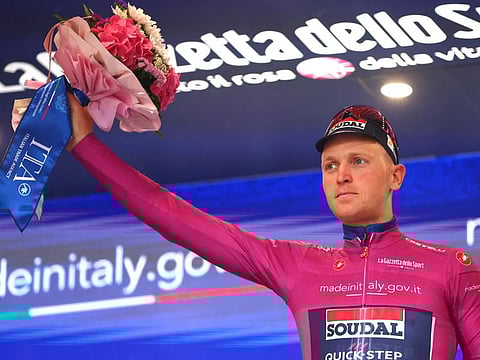 Team Soudal-Quick Step's Belgian rider Tim Merlier celebrates on the podium after winning the 3rd stage of the 107th Giro d'Italia cycling race, 166 km between Novara and Fossano, on Monday.