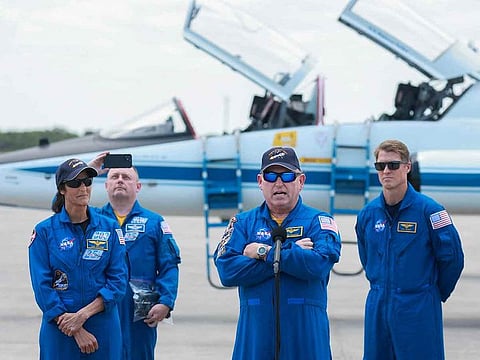 NASA’s Boeing Crew Flight Test Commander Butch Wilmore (C) and Pilot Sunita Williams (L) address the media after arriving at the Kennedy Space Center on April 25, 2024 in Cape Canaveral, Florida.