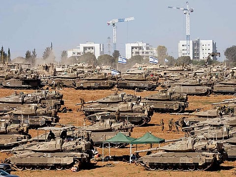 Israeli soldiers stand next to military vehicles, amid the ongoing conflict between Israel and the Palestinian Islamist group Hamas, near the Israel-Gaza Border, in southern Israel, May 7, 2024.