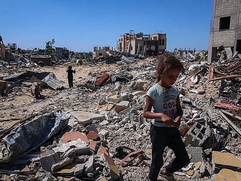 Displaced Palestinians inspect their destroyed homes after fleeing from Rafah, in central Khan Younis, Gaza, on Tuesday, May 7, 2024