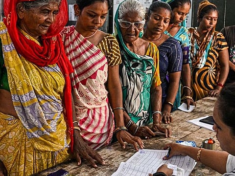 Women voters register at a polling station during the third phase of voting for national elections in Ahmedabad, Gujarat, India, on Tuesday, May 7, 2024.
