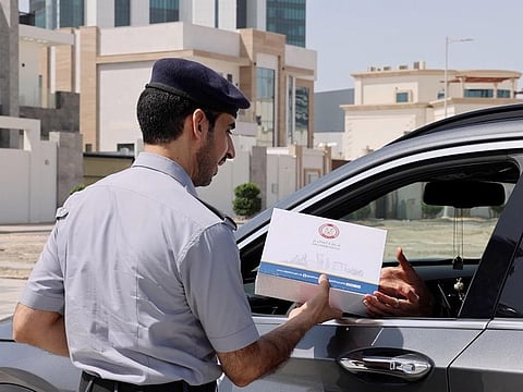 Abu Dhabi Police rewarding a responsible motorist as part of Arab Traffic Week, which ends on May 10