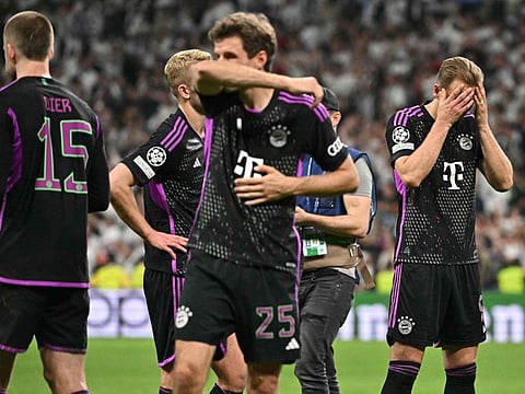 Bayern Munich's English forward Harry Kane (right) and teammates react to their defeat after the Uefa Champions League semi-final second leg football match against Real Madrid CF at the Santiago Bernabeu stadium in Madrid on Wednesday.