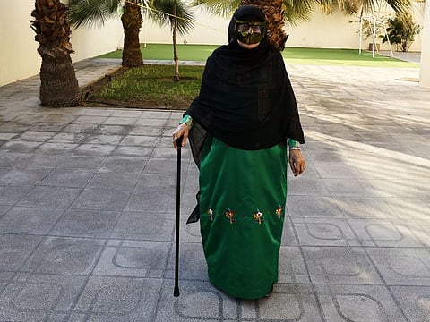 Grandma Mouza Hassan, 79, taking a walk in her villa garden in Ajman.