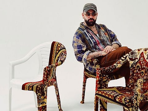 Ali Cha’aban sat on one of his Monobloc chairs covered with Persian rugs, 2023.