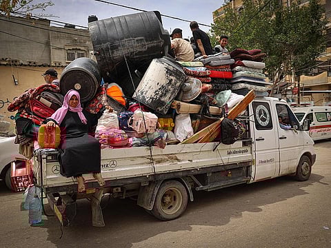 Palestinians pile their belongings on a vehicle as it drives to safer areas in Rafah, in the southern Gaza Strip, on May 10, 2024, amid the ongoing conflict between Israel and the militant group Hamas.