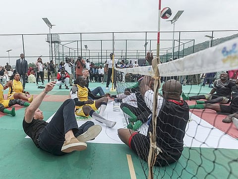 Britain's Prince Harry (2nd left), Duke of Sussex, takes part in an exhibition sitting volleyball match at Nigeria Unconquered, a local charity organisation that supports wounded, injured, or sick servicemembers, in Abuja on May 11, 2024 as they visit Nigeria as part of celebrations of Invictus Games anniversary.