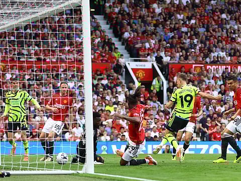 Arsenal's Leandro Trossard scores their first goal during a Premier League match against Manchester United at Old Trafford on Sunday.