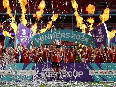 Manchester United's Katie Zelem celebrates with the trophy and teammates after winning the women's FA Cup at Wembley Stadium, London, on Sunday.
