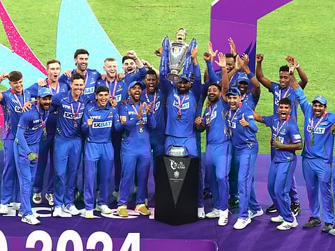 MI Emirates players with the trophy after winning the final of the DP World International League T20 at the Dubai International Stadium in February.