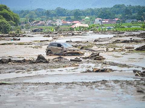 A damaged car is seen in an area affected by heavy rain brought flash floods and landslides in Agam, West Sumatra province, Indonesia.