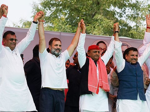 Congress leader Rahul Gandhi, Samajwadi Party (SP) chief and party candidate from Kannauj seat Akhilesh Yadav, Aam Aadmi Party (AAP) leader Sanjay Singh and others hold hands during the public meeting for the Lok Sabha elections, in Kannauj on Friday.