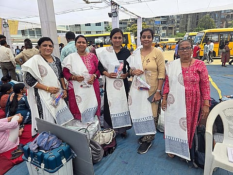 Valsad, May 06 (ANI): Polling officials pose for a picture after collecting the EVMs and other election materials for the 3rd phase of the Lok Sabha polls, in Valsad on Monday.