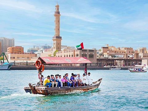 People onboard a traditional wooden boat, called abra, in Dubai Creek