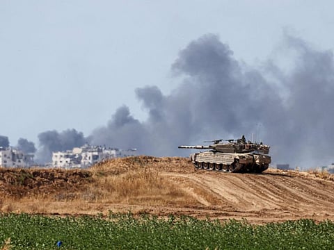 Israeli battle tanks take position in southern Israel near the border with the Gaza Strip on May 13, 2024.