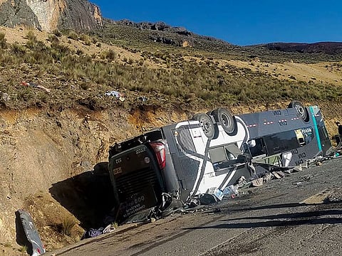The bus overturned and rolled down a slope, landing upside down.