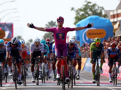Team Lidl-Trek's Italian rider Jonathan Milan (centre) celebrates as he crosses the finish line to win the 11th stage of the 107th Giro d'Italia cycling race.
