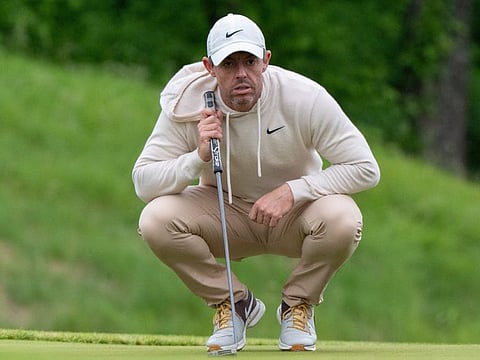 Rory McIlroy reads his putt on the 13th putting green during a practice round for the PGA Championship golf tournament at Valhalla Golf Club.