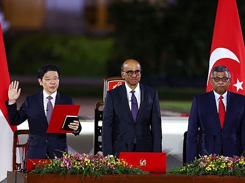Singapore's Deputy Prime Minister and Minister of Finance Lawrence Wong, Singapore's President Tharman Shanmugaratnam and Chief Justice Sundaresh Menon stand, as Wong is sworn in as Singapore's fourth Prime Minister at the Istana, in Singapore, May 15, 2024.