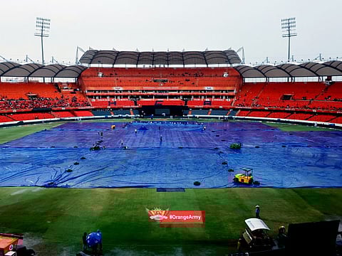 Ground staff cover the Rajiv Gandhi International Stadium after rain delays the toss for the match between Sunrisers Hyderabad and Gujarat Titans in the Indian Premier League 2024, in Hyderabad on Thursday.