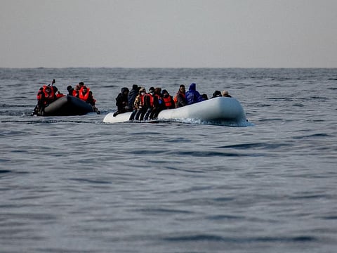 Two inflatable dinghies carrying migrants make their way towards England in the English Channel, Britain.