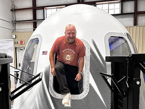 This undated photo provided by North Communication shows French entrepreneur Sylvain Chiron emerging from the Blue Origin space capsule in Van Horn, Texas.