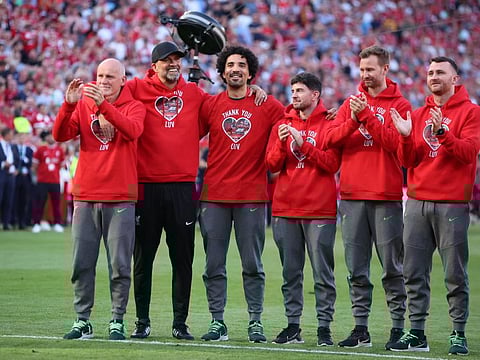 Liverpool manager Juergen Klopp applauds fans with his coaching staff after his last match as Liverpool manager at Anfield on Sunday.
