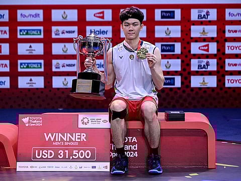 Malaysia's Lee Zii Jia poses with the trophy during the men's singles trophy presentation at the 2024 Thailand Open badminton tournament in Bangkok on Sunday.