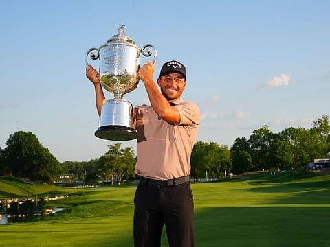 Xander Schauffele hoists the Wanamaker Trophy