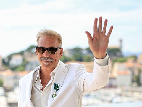 US director Kevin Costner poses after being awarded Chevalier de l'Ordre des Arts et des Lettres, on the sidelines of the 77th edition of the Cannes Film Festival in Cannes, southern France, on May 19, 2024. (Photo by Valery HACHE / AFP)