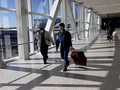 Air travellers wearing protective face masks, amid the coronavirus disease (COVID-19) pandemic. (File photo)