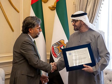 Sheikh Mohamed bin Zayed Al Nahyan (R), receives the ‘Global Humanitarian Personality’ award, presented by Antonio Pedro Roque da Visitacao Oliveira, President of The Parliamentary Assembly of the Mediterranean (L).