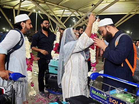 Hajj pilgrims being garlanded by their family members as they leave for pilgrimage to Mecca, at IGI airport in New Delhi.