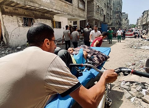 Palestinians evacuate Kamal Adwan hospital following an Israeli strike, amid the ongoing conflict between Israel and the Palestinian Islamist group Hamas, in Beit Lahia in the northern Gaza Strip, May 21, 2024.
