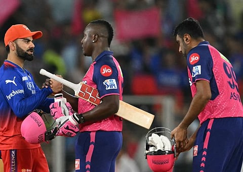 Royal Challengers Bengaluru's Virat Kohli greets Rajasthan Royals' Rovman Powell (C) after their win in the Indian Premier League (IPL) Twenty20 eliminator cricket match at the Narendra Modi Stadium in Ahmedabad on Wednesday.