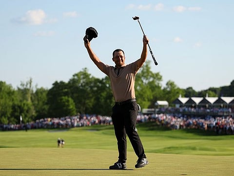 Xander Schauffele celebrates on the 18th green after winning the PGA Championship