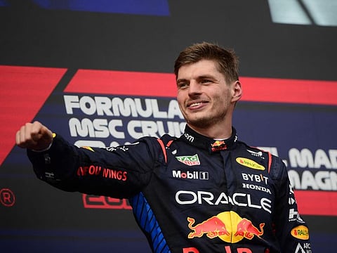 Red Bull's Max Verstappen celebrates on the podium after winning the Emilia Romagna Grand Prix.