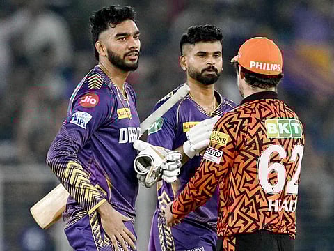 Kolkata Knight Riders' captain Shreyas Iyer (C) and Venkatesh Iyer (L) are congratulated by Sunrisers Hyderabad's Travis Head after their team's win at the IPL first qualifier in the Narendra Modi Stadium of Ahmedabad on May 21, 2024.