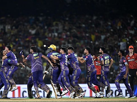 Kolkata Knight Riders' players celebrate their victory as Sunrisers Hyderabad's captain Pat Cummins (R) watches at the end of the Indian Premier League Twenty20 final on Sunday.