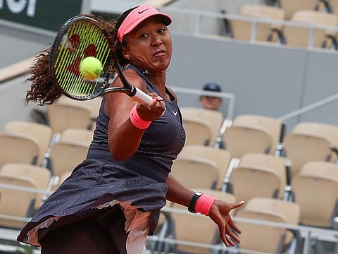 Japan's Naomi Osaka plays a forehand return to Italy's Lucia Bronzetti during their women's singles match on day one of The French Open tennis tournament on Court Philippe-Chatrier at The Roland Garros Complex in Paris on Sunday.