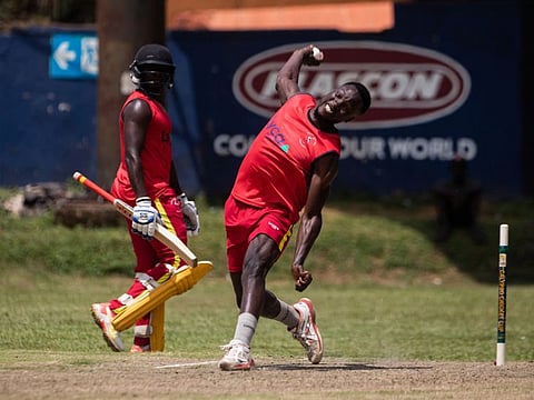 Uganda National Cricket team's Siraje Nsubuga bowls during a practice session at the Lugogo Cricket Oval in Kampala.