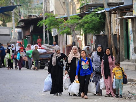 Palestinians flee the area of Tal Al Sultan in Rafah with their belongings following renewed Israeli strikes in the city in the southern Gaza Strip on May 28, 2024.