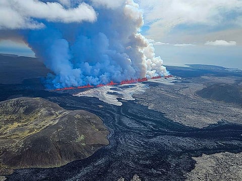 Billowing smoke and flowing lava pouring out of a new fissure, during a surveilance flight above a new volcanic eruption on the outskirts of the evacuated town of Grindavik, western Iceland.
