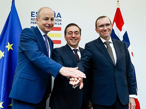 Spanish Minister for Foreign Affairs, European Union and Cooperation, Jose Manuel Albares (C), Norwegian Foreign Minister Espen Barth Eide (R) and Irish Foreign minister Micheal Martin join hands after holding a joint press conference at the the Permanent Representation of Spain to the European Union in Brussels on May 27, 2024. Ireland, Norway and Spain's governments decided to recognise a Palestinian state from next week.