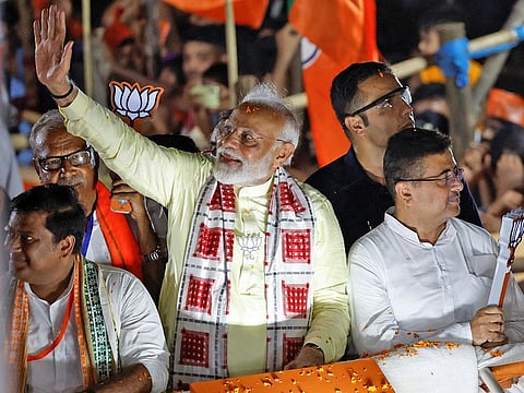 India's Prime Minister Narendra Modi waves towards his supporters during a roadshow as part of an election campaign, in Kolkata, India, May 28, 2024.