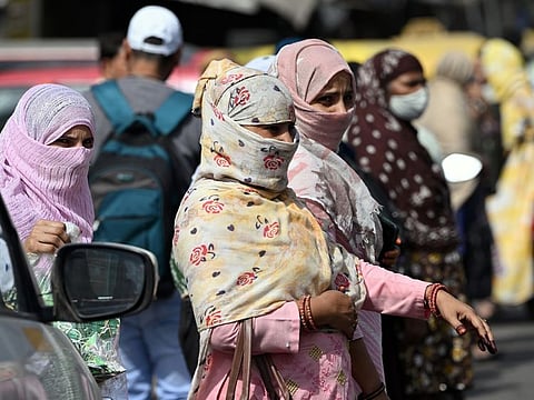 Pedestrians on a New Delhi street on May 30, 2024. Temperatures at a weather observatory in India’s capital city touched 52.9C (127F) on Wednesday, evidence of a worsening heat wave that also sent peak electricity demand in Delhi to an all-time high.